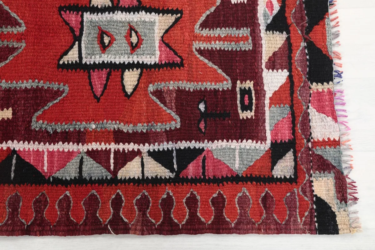 Detailed view of the rug's edge and a section of the tribal geometric design