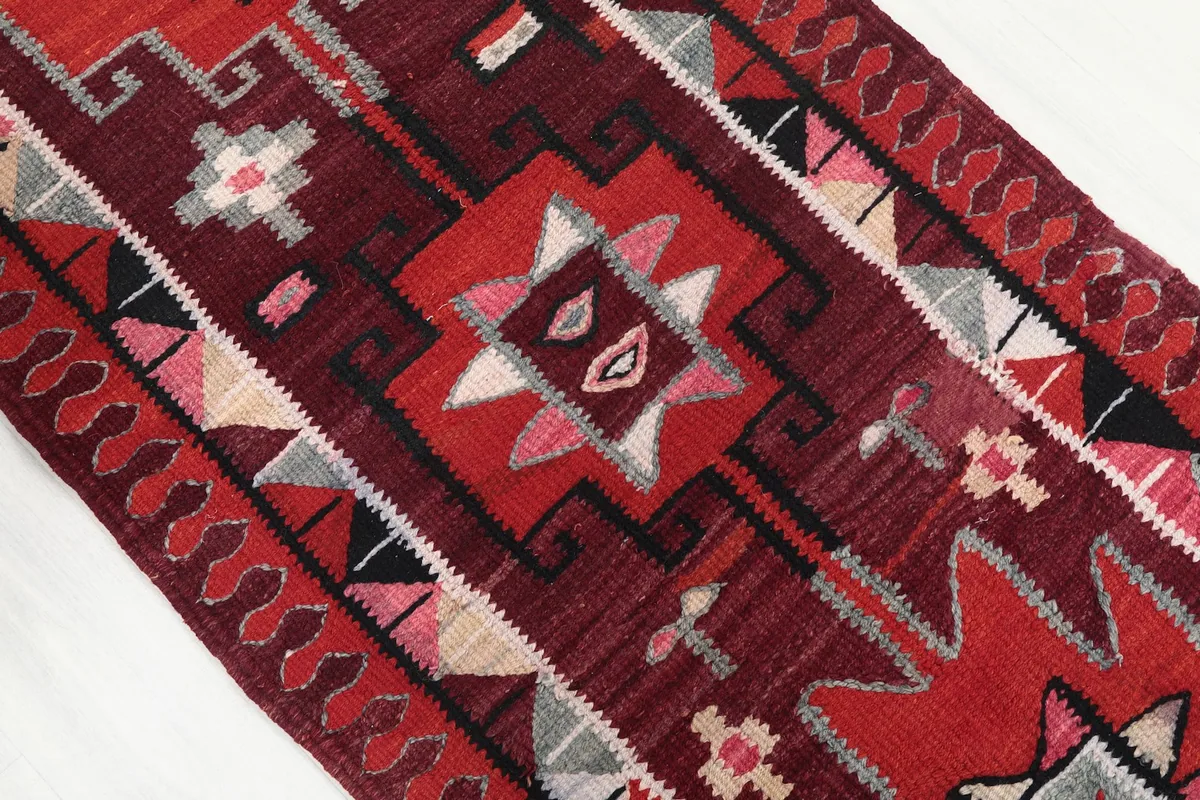 Close-up of the central geometric motifs and the subtle color variations in the pile