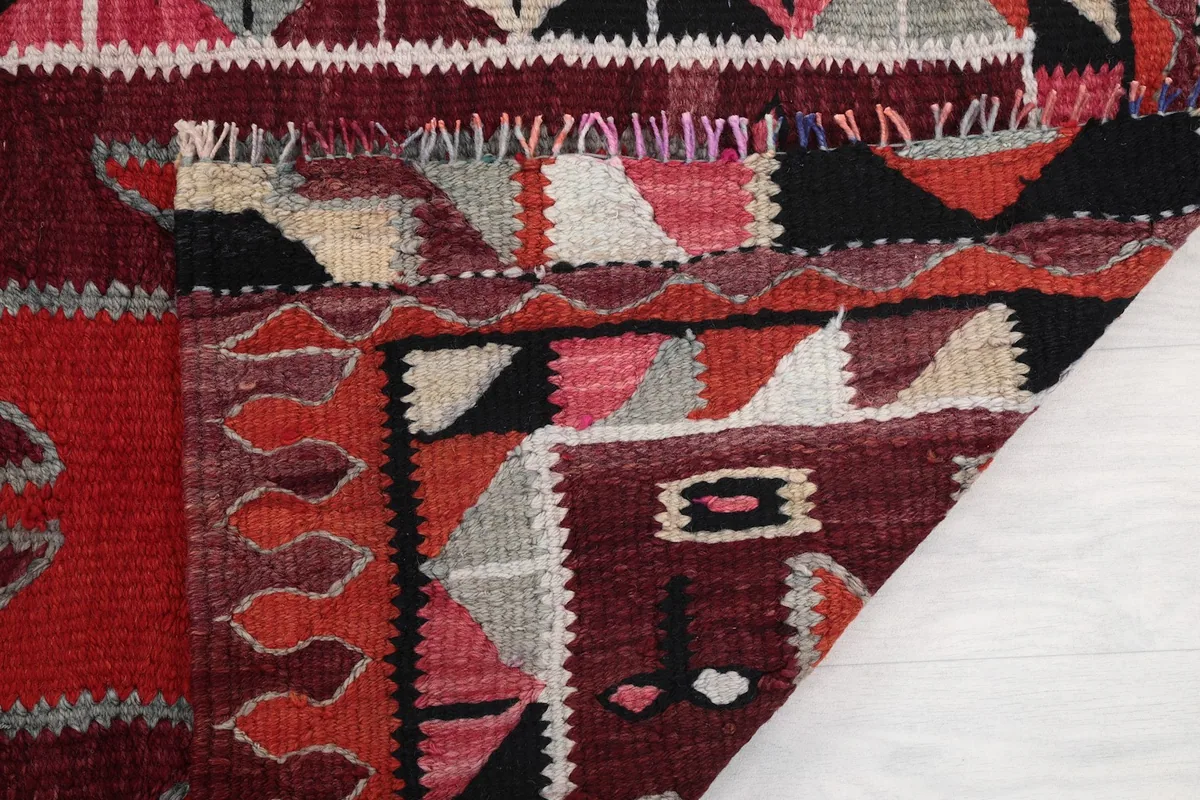 Close-up of the rug's low wool pile and the texture of its hand-knotted construction