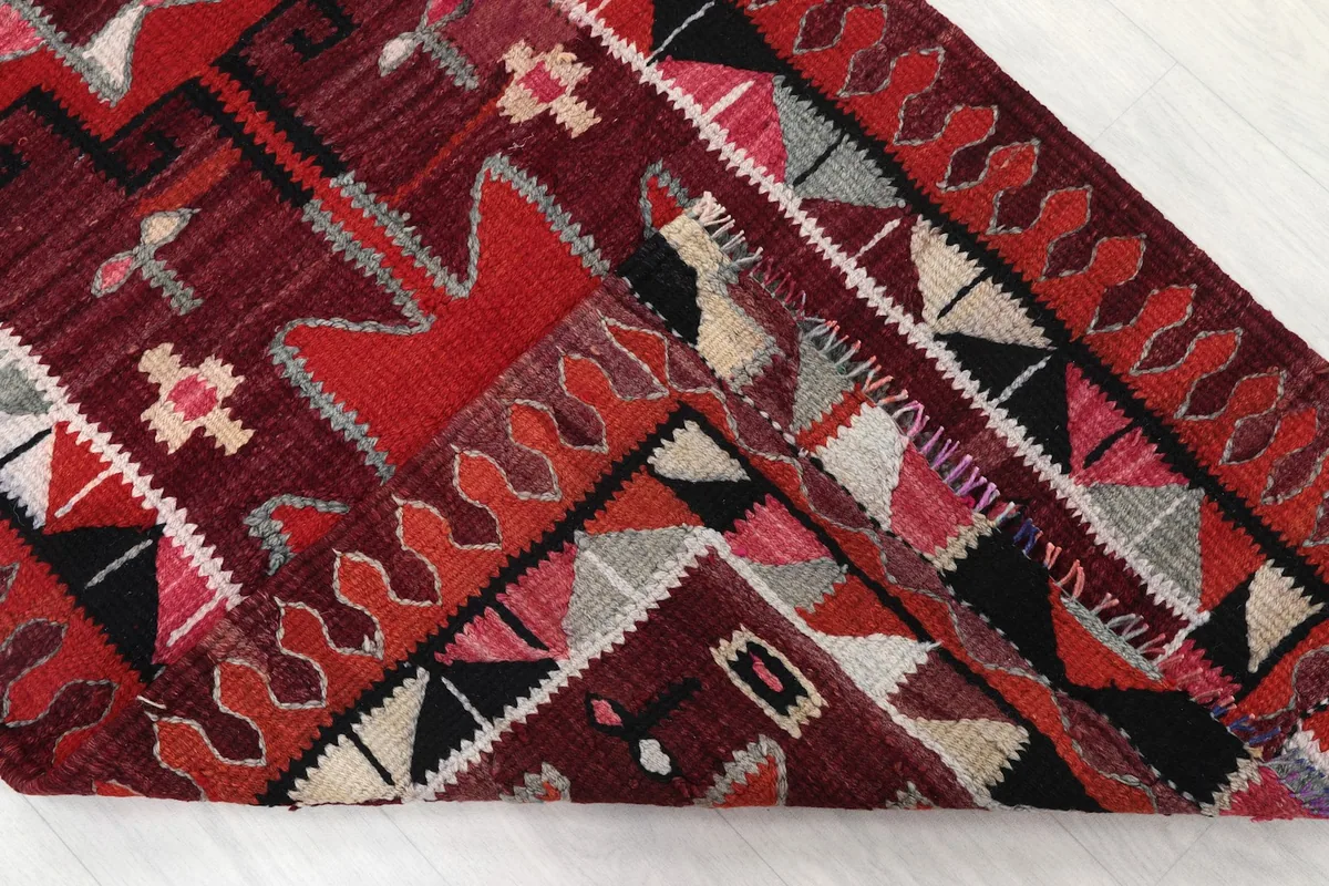 View of the rug's underside, revealing the hand-knotted cotton foundation and wool pile