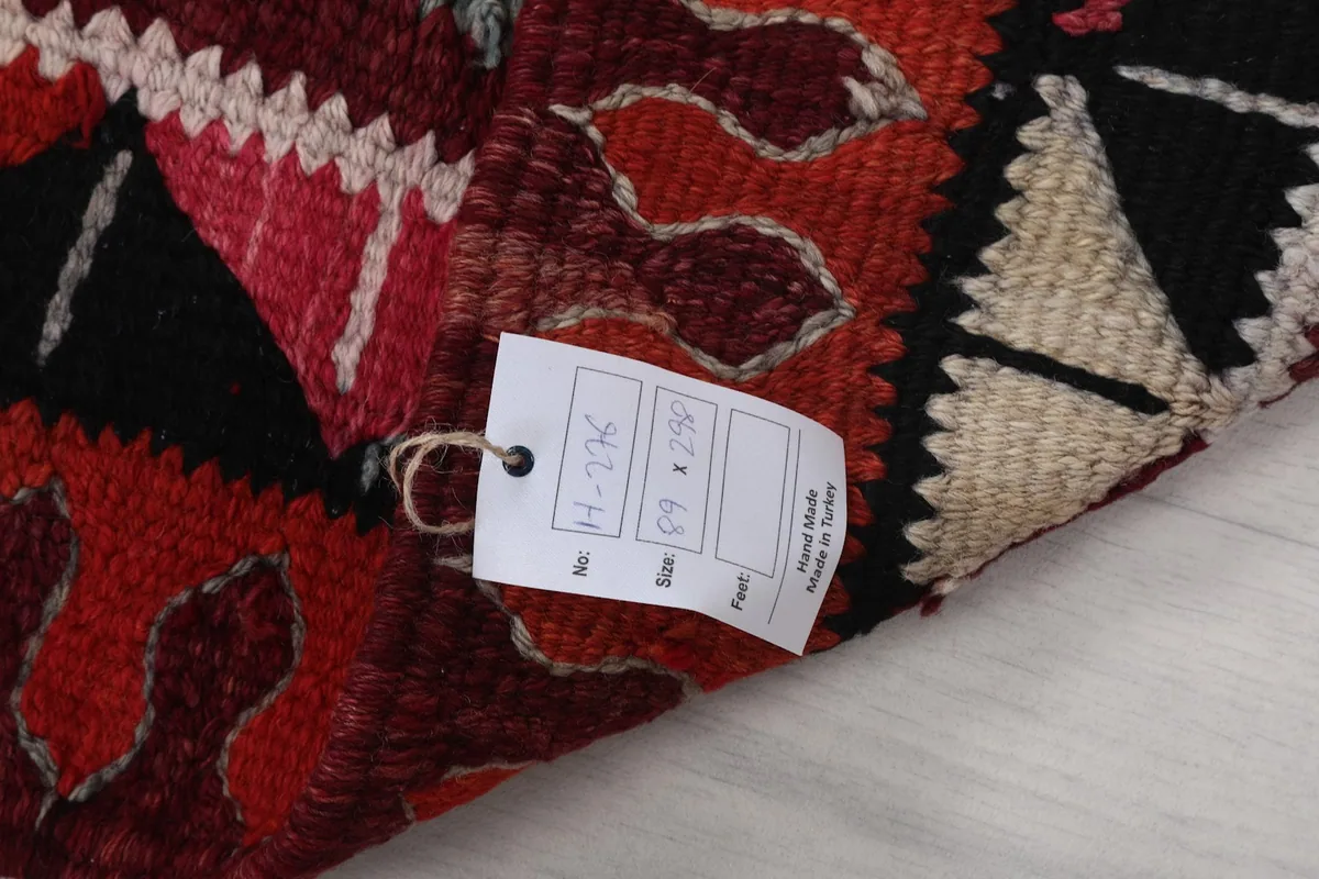 Close-up of the product tag attached to the rug, showing size and origin details