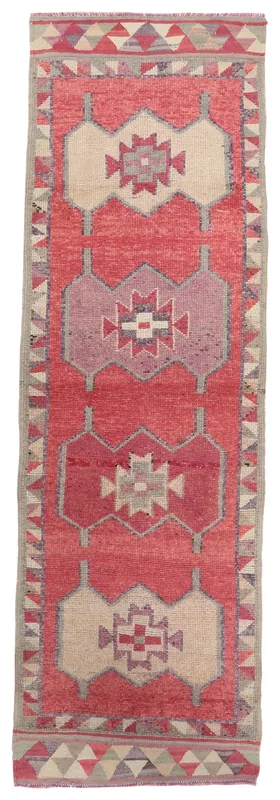 Full overhead view of the hand-knotted rose and beige geometric Anatolian runner rug
