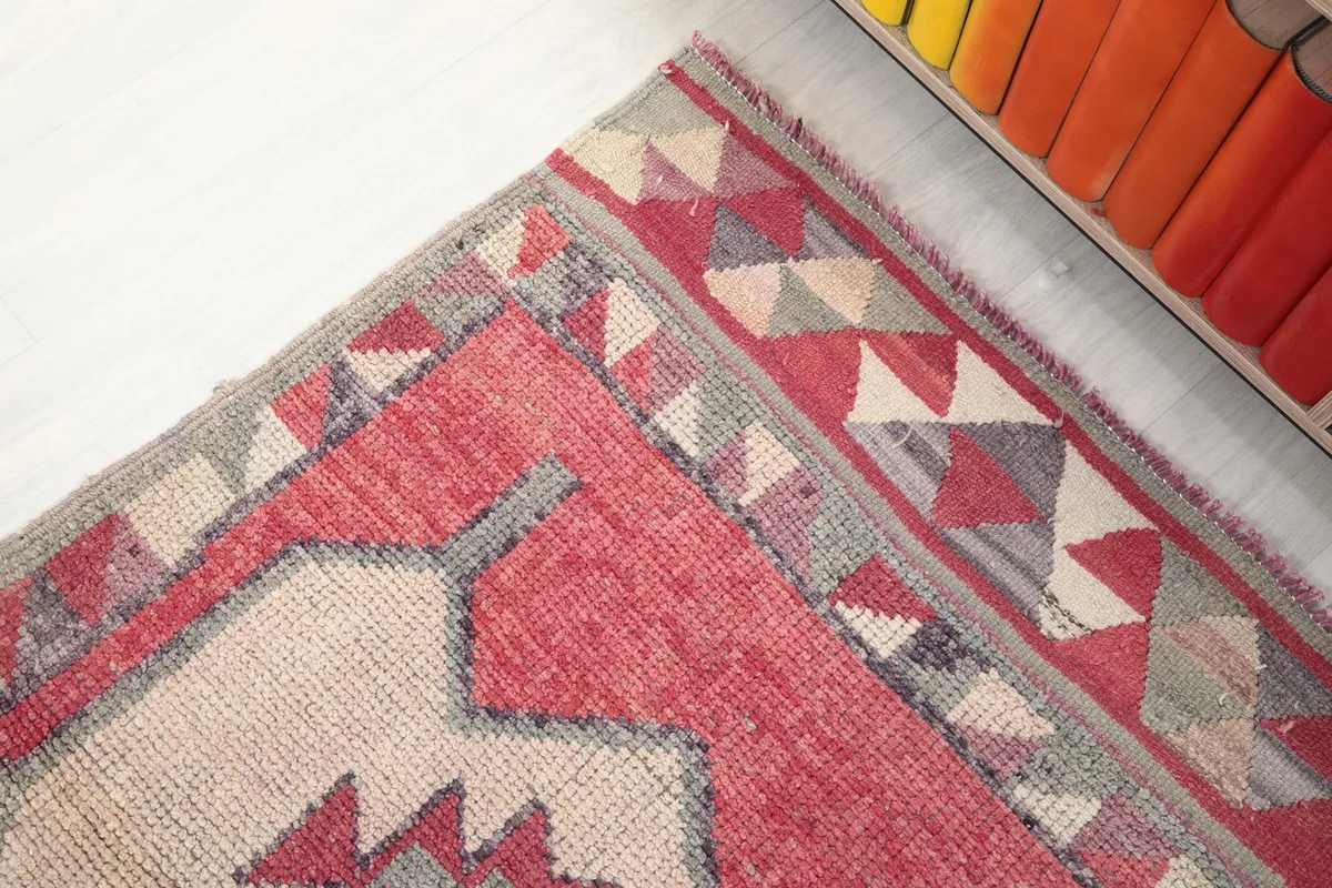 Detailed view of the rug's tribal border pattern and edge