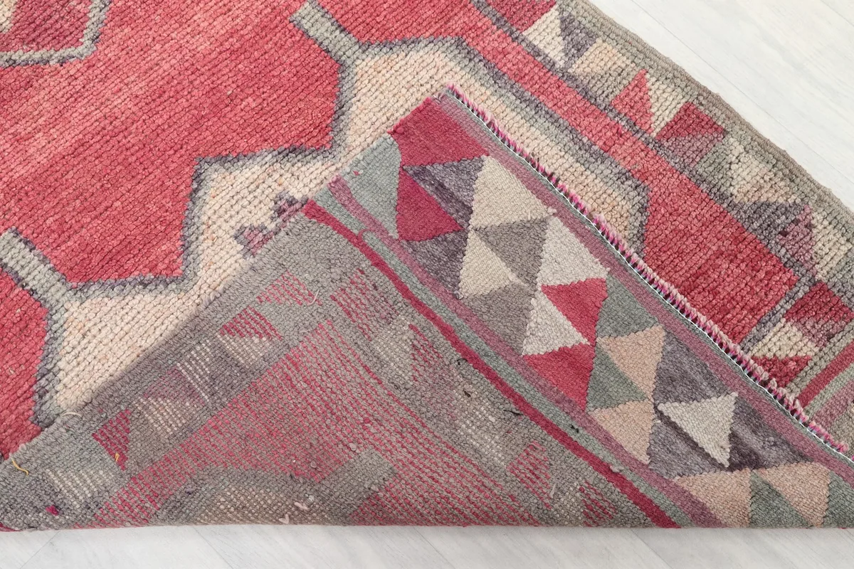 View of the rug folded to show the hand-knotted wool pile and cotton foundation