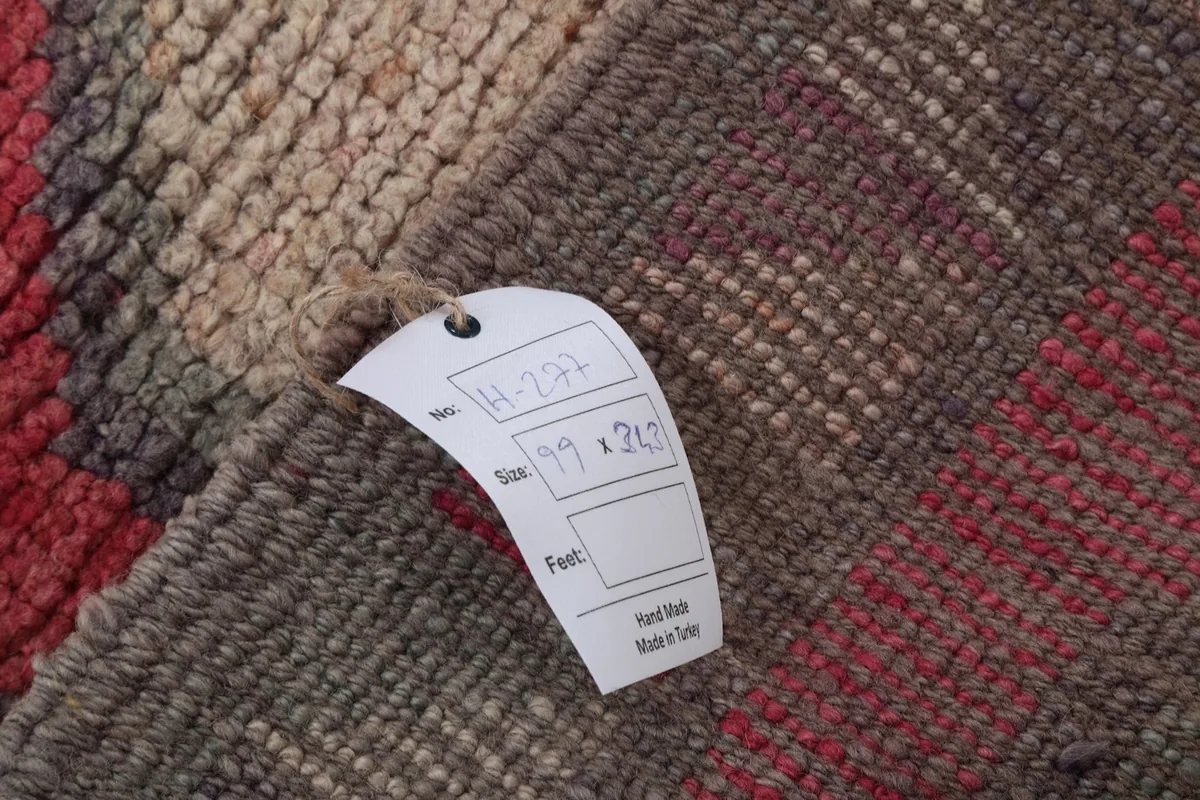 Close-up of the rug's back with a product tag showing dimensions and origin