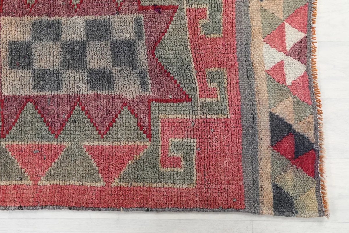 Detailed view of the geometric patterns and colors at one end of the runner