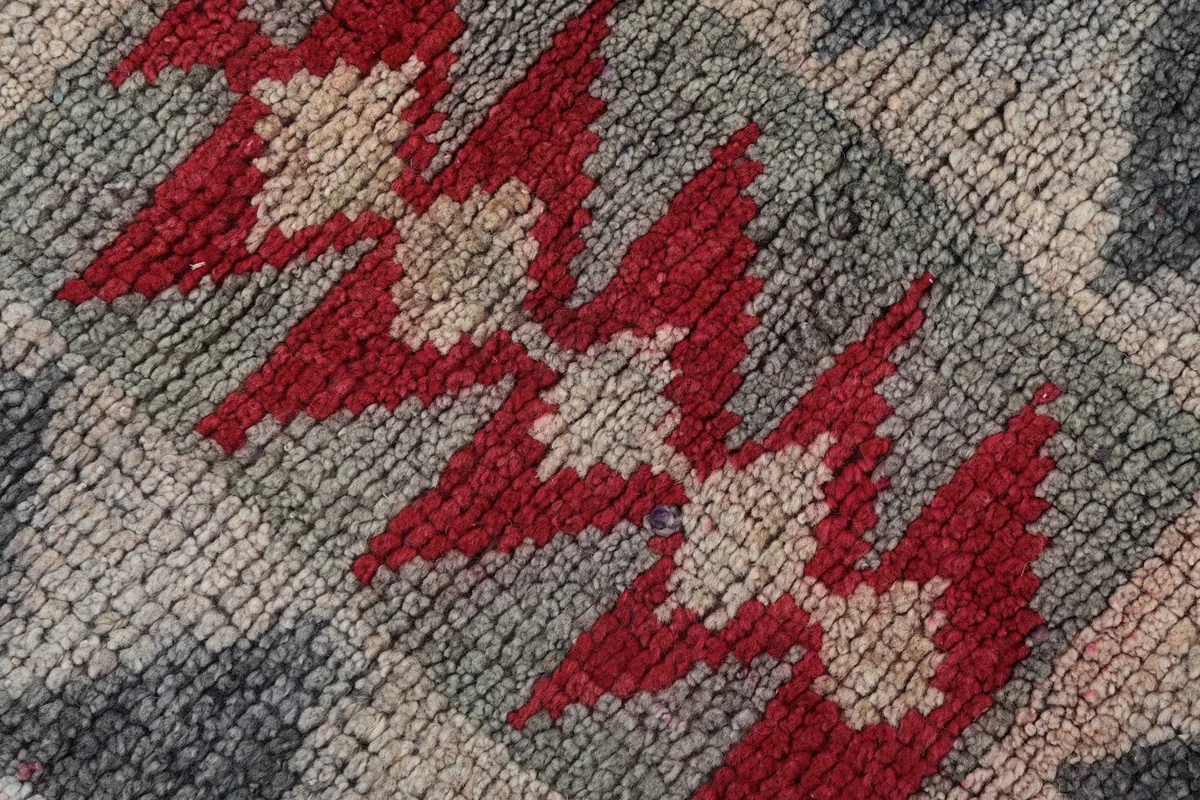 Extreme close-up showing the texture of the low wool pile and hand-knotted knots