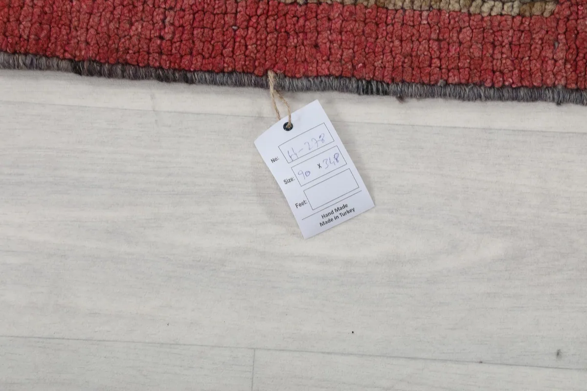 Close-up of a product tag attached to the rug, indicating its origin and material