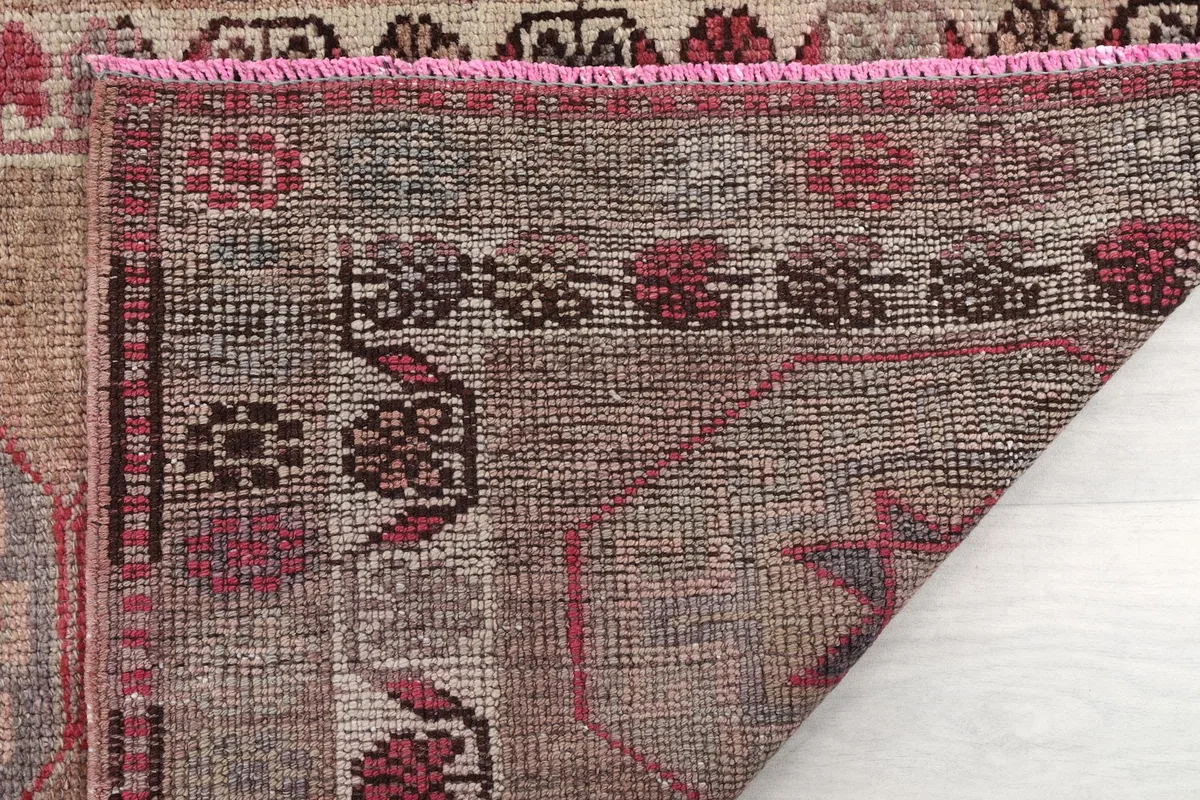 Close-up of the reverse side of the rug, showing the details of the hand-knotting and fringe.