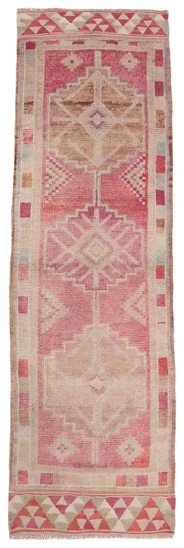 Full overhead view of the vintage Anatolian runner rug with rose and tan geometric patterns