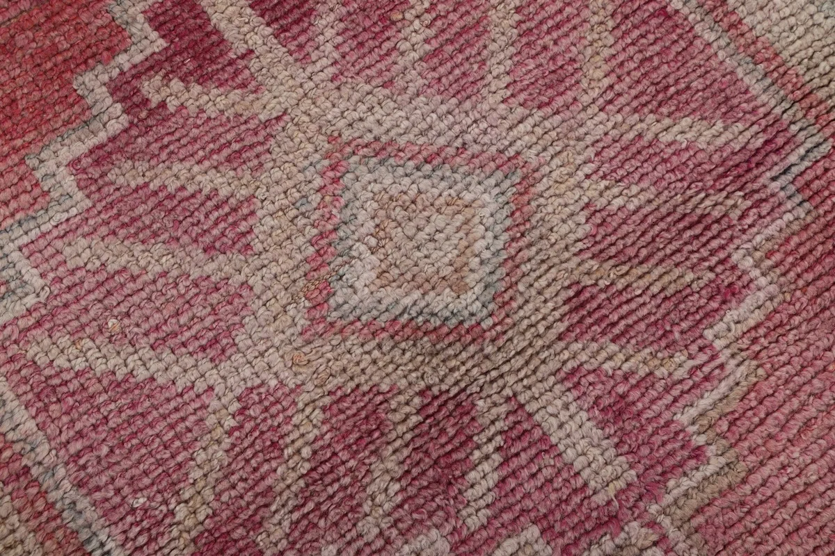Extreme close-up of the hand-knotted wool pile, revealing the intricate weave and color variations