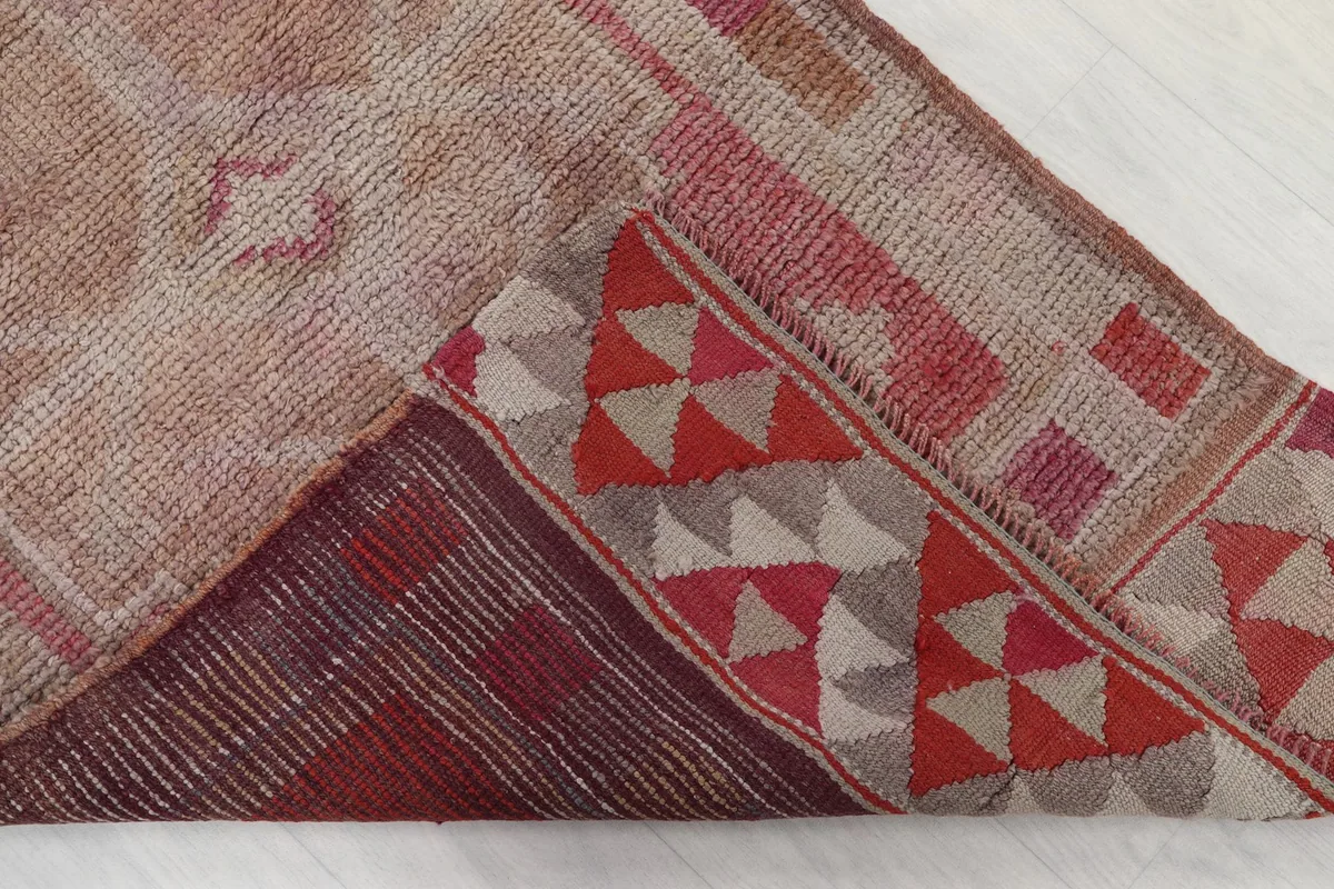 View of the rug's underside, revealing the cotton foundation and construction