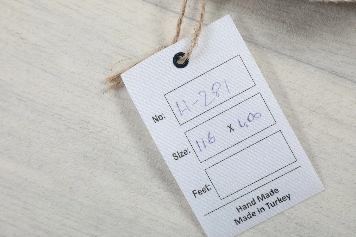 Product tag indicating the rug number, size in centimeters, and origin from Turkey.