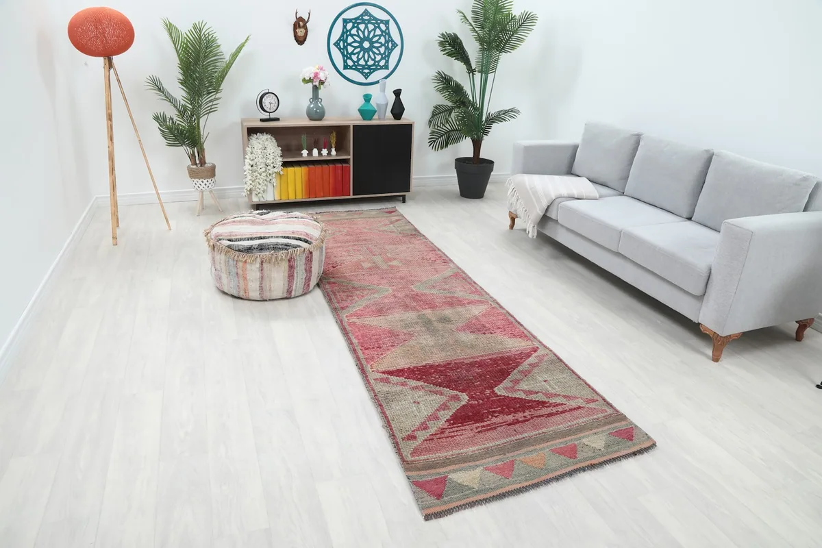 Long view of the rose and gray runner rug extending through a contemporary living space