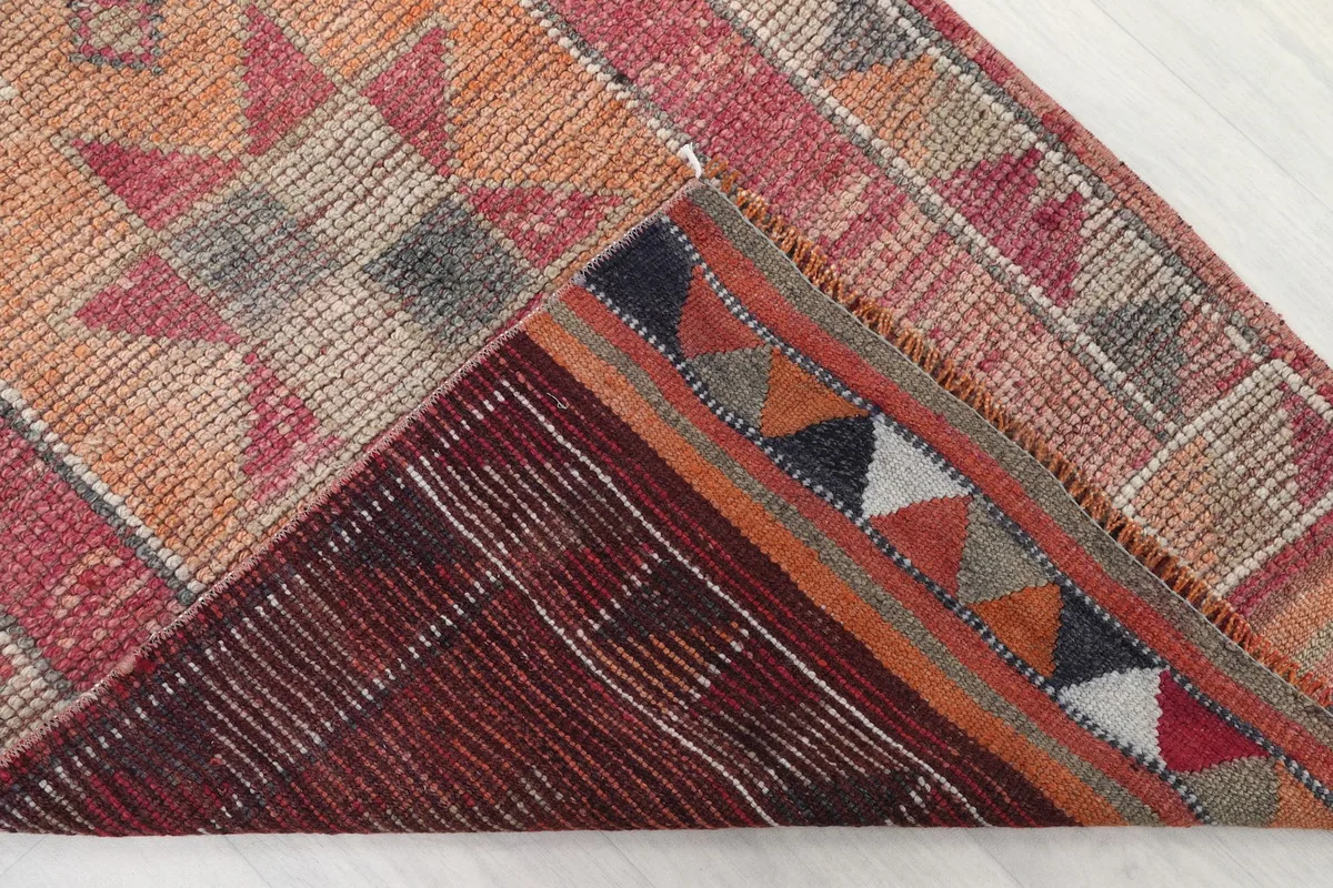 Underside view of the rug, revealing the cotton foundation and hand-knotted construction.