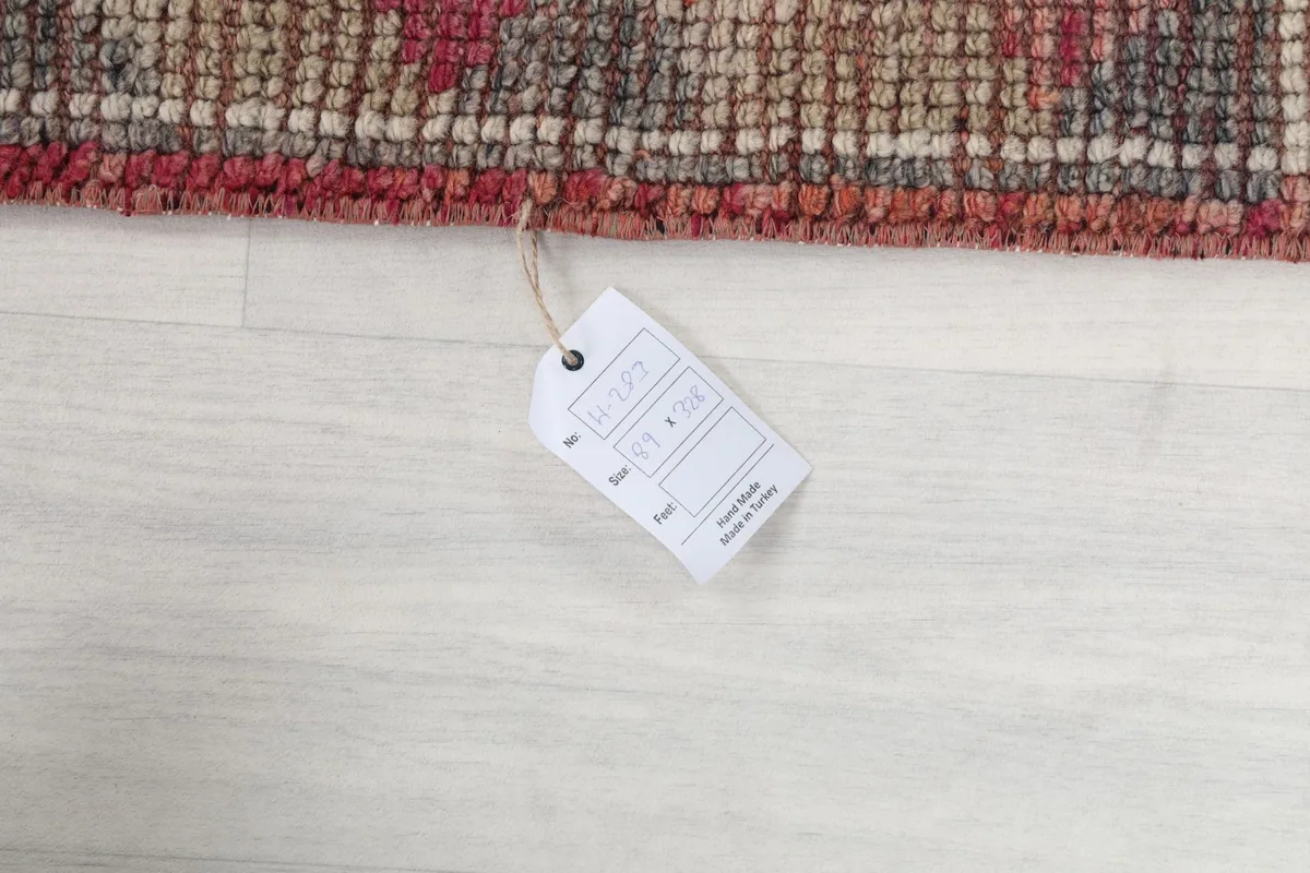 Rug tag displaying size information and origin, attached to the corner of the runner.
