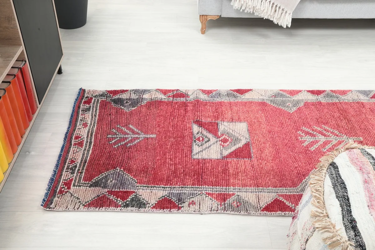 Angled view looking down the length of the runner rug in the room