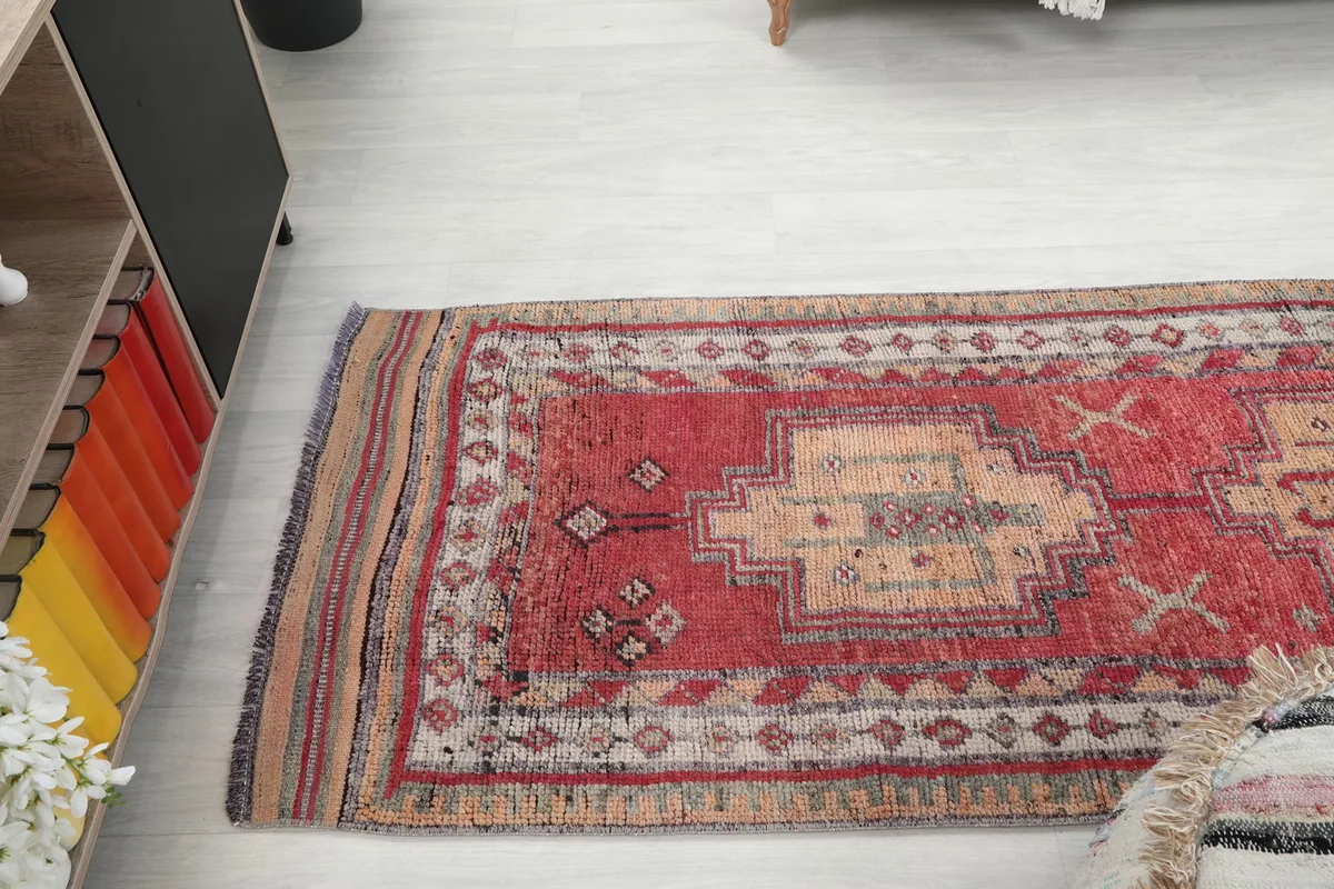 Angled view of the runner rug extending down a hallway, showing its long shape