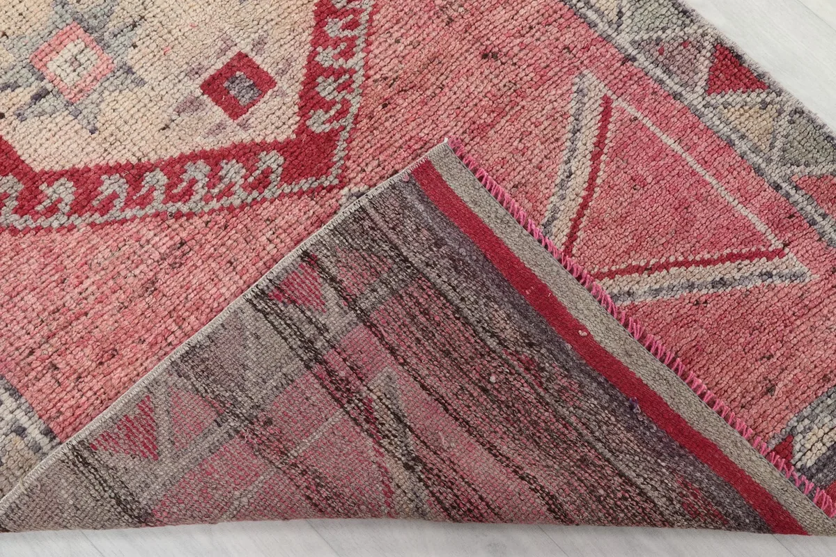 View of the back of the rug, showing the cotton foundation and hand-knotted structure.