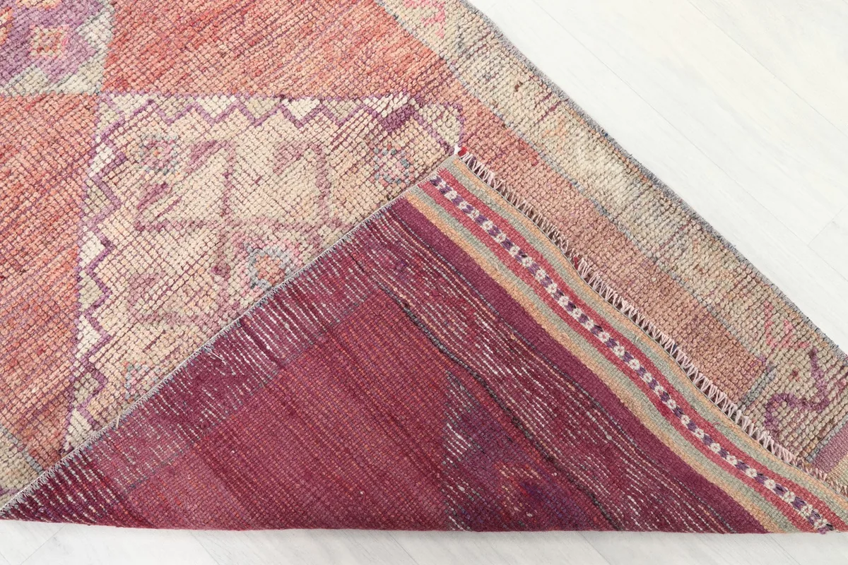 Underside view of the hand-knotted vintage rug, revealing the cotton foundation and construction