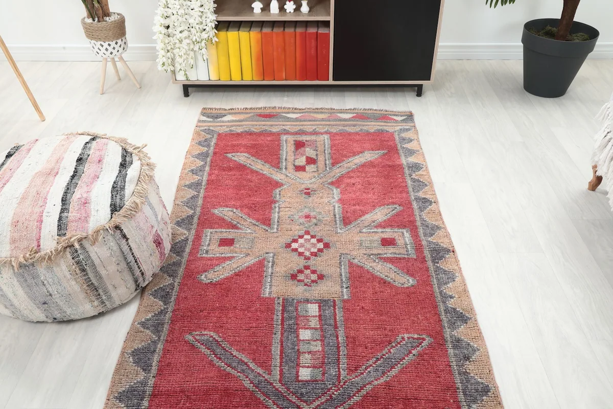 Overhead view of the Red Tribal Figure Runner in a room, focusing on the central design