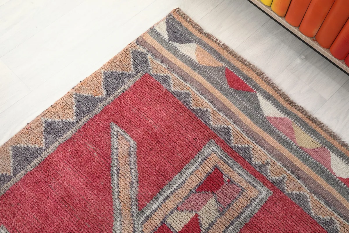Corner detail of the runner, highlighting the geometric border patterns and colors