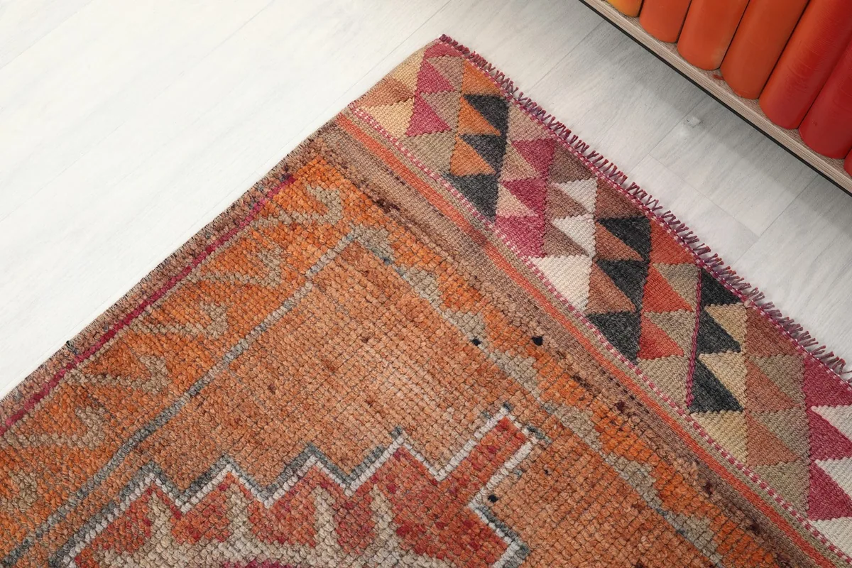 Close-up of the end border with colorful triangle patterns and the rug's texture