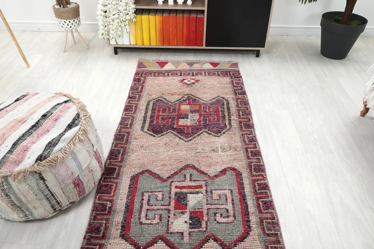 Overhead view of the runner rug placed in a room with a sofa and ottoman