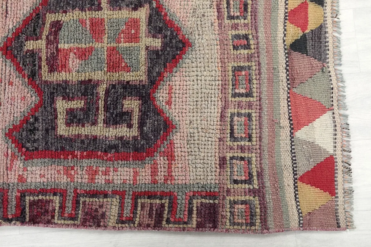 Close-up of the rug's border with a geometric pattern and end finish