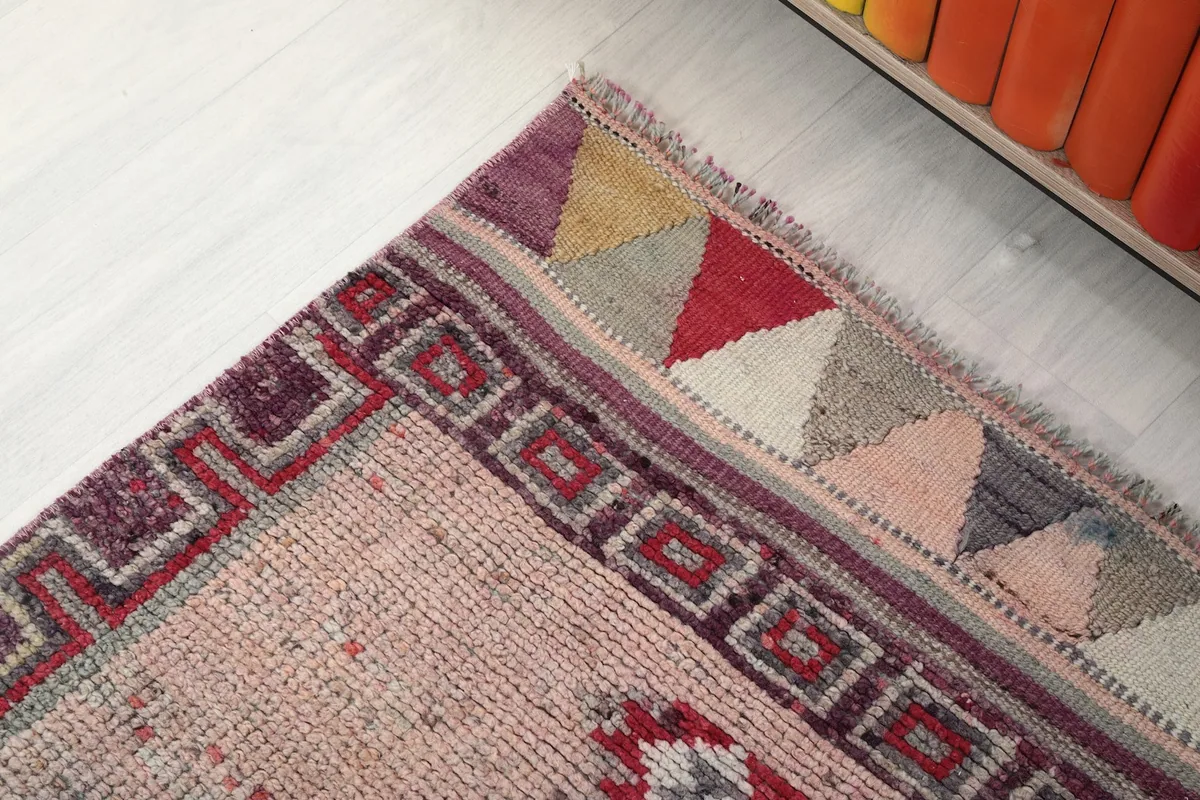Corner detail of the runner rug showing the border and fringe