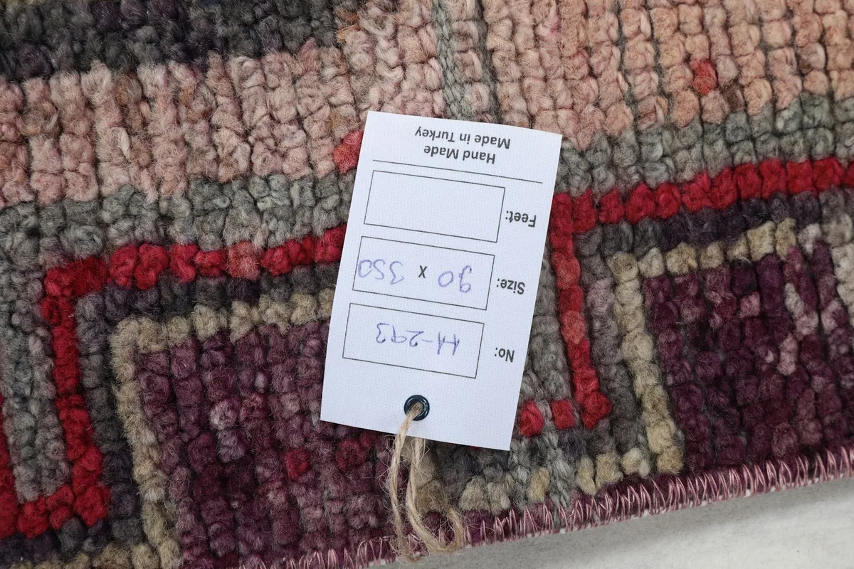 Tag showing the rug's size in centimeters and inches, and origin