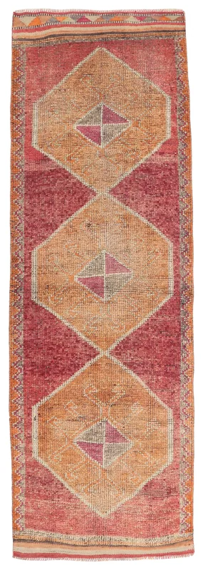 Overhead view of the 3'3" x 10'1" rust and orange geometric vintage runner