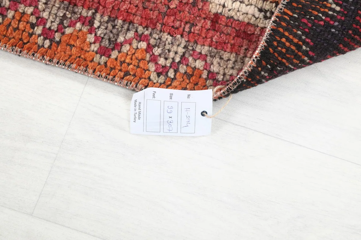 Rug corner showing the back of the rug and a size tag