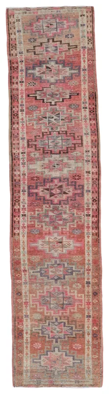 Full top view of the 2'8" x 13'2" vintage Anatolian runner rug with faded rose and gray tribal geometric patterns