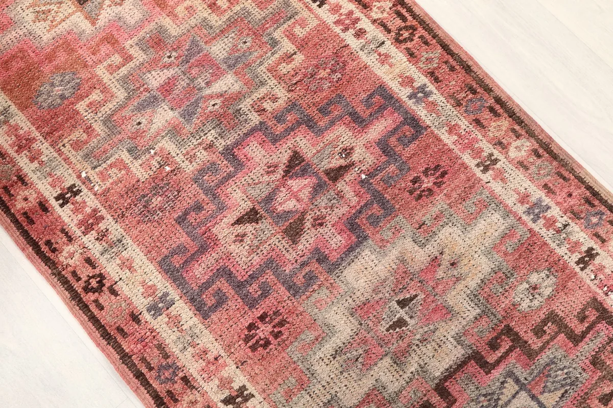 Overhead close-up of the central geometric patterns and color blending in rose, gray, and brown tones