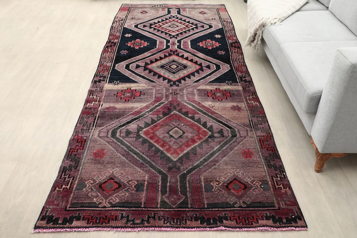 Anatolian runner rug in a living room setting with a gray sofa