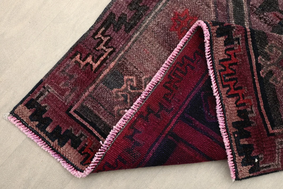 Folded corner showing the reverse side of the hand-knotted runner