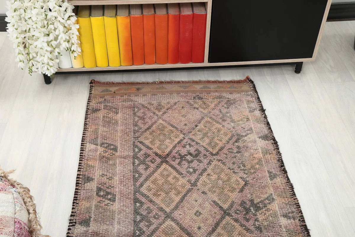 Overhead view of one end of the runner rug, extending from under a console table