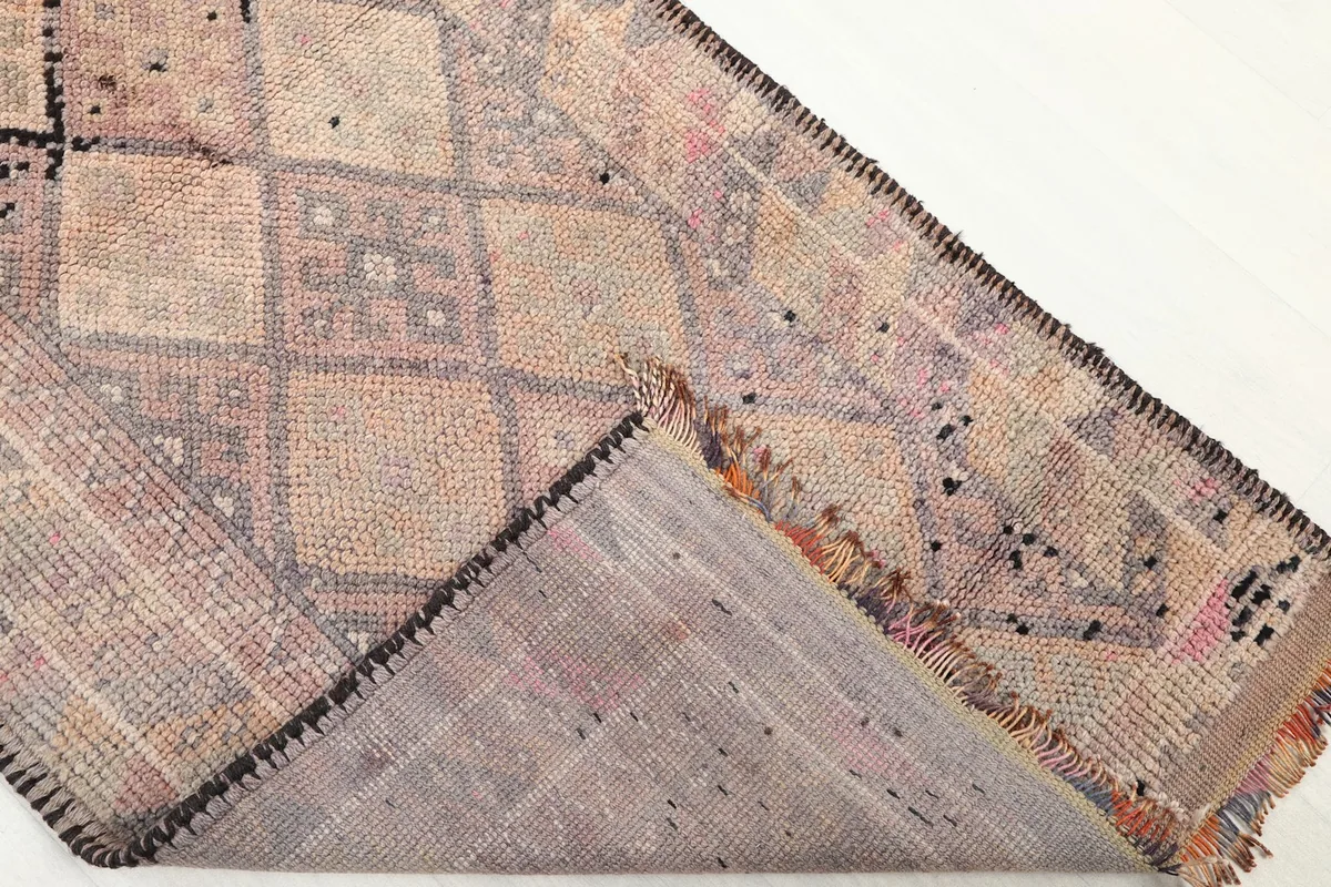 View of the back of the hand-knotted rug, showing the cotton foundation and knotting