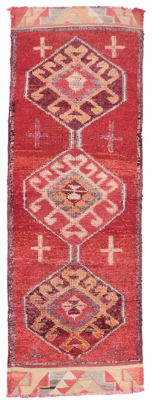 Full top view of the vintage red tribal geometric runner rug on a white background.