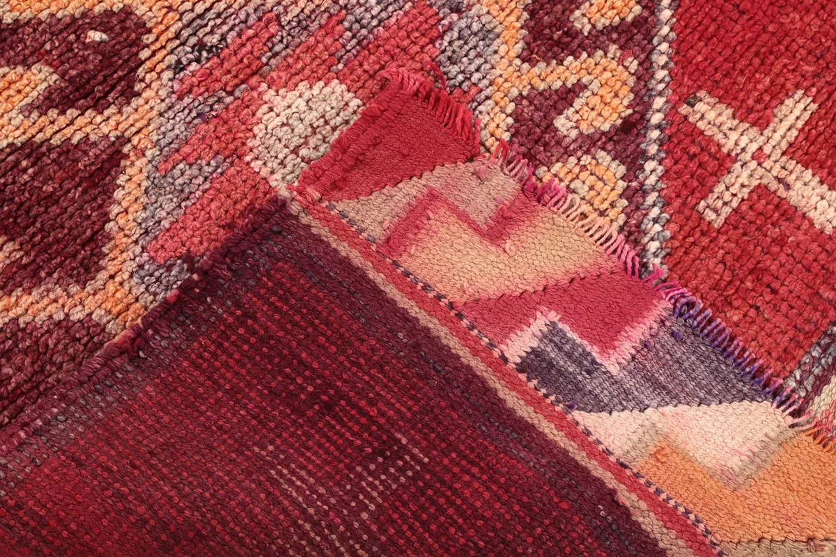 View of the back of the rug, showing the cotton foundation and hand-knotted construction.
