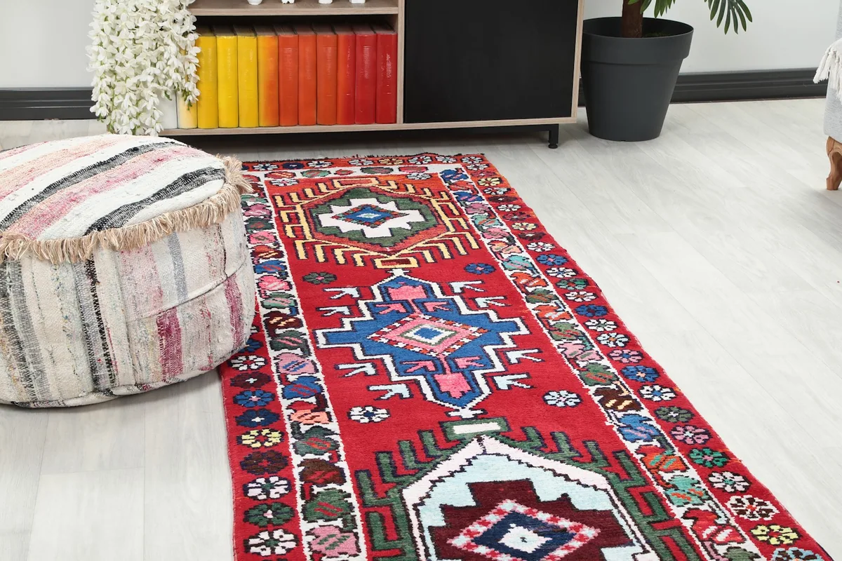 Close-up view of the central geometric motifs and colors of the vintage Anatolian runner