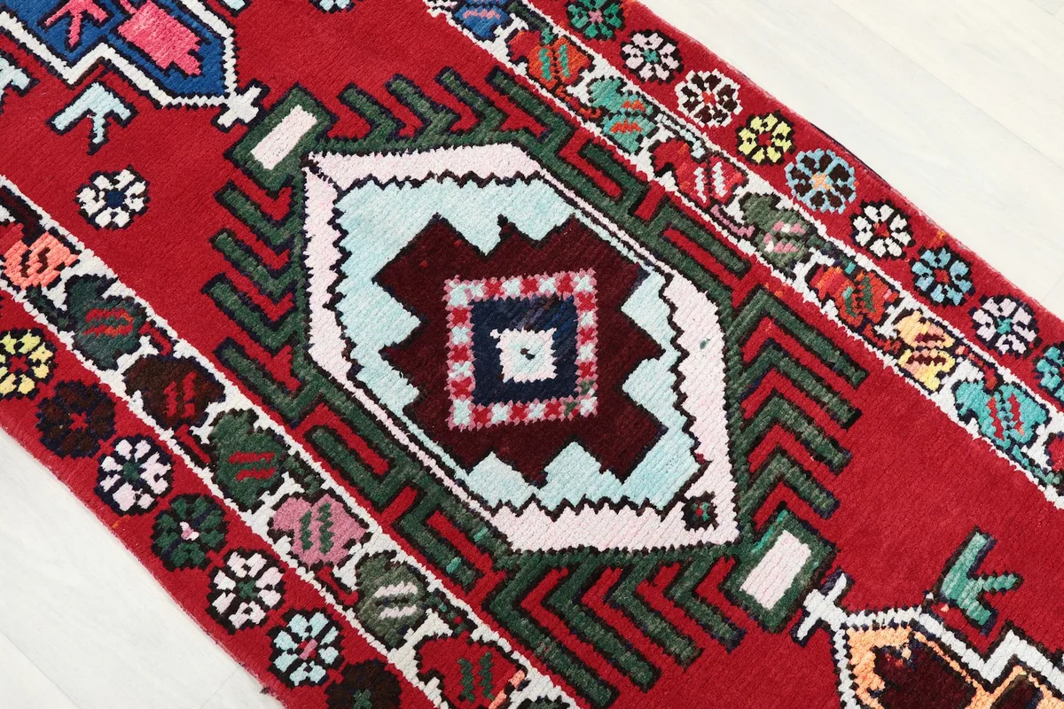Angled close-up showing the varied geometric designs and colors within the rug's pattern