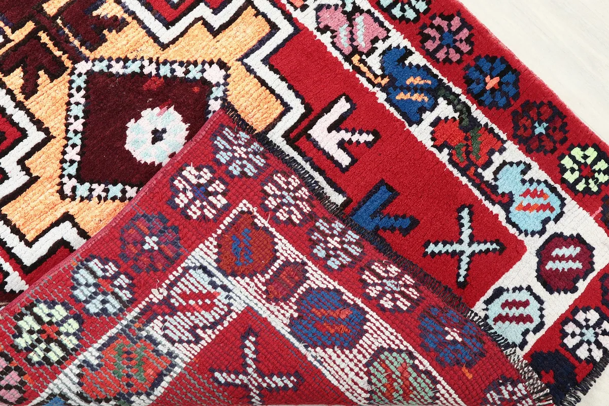 Close-up of the back of the hand-knotted runner rug, revealing its construction