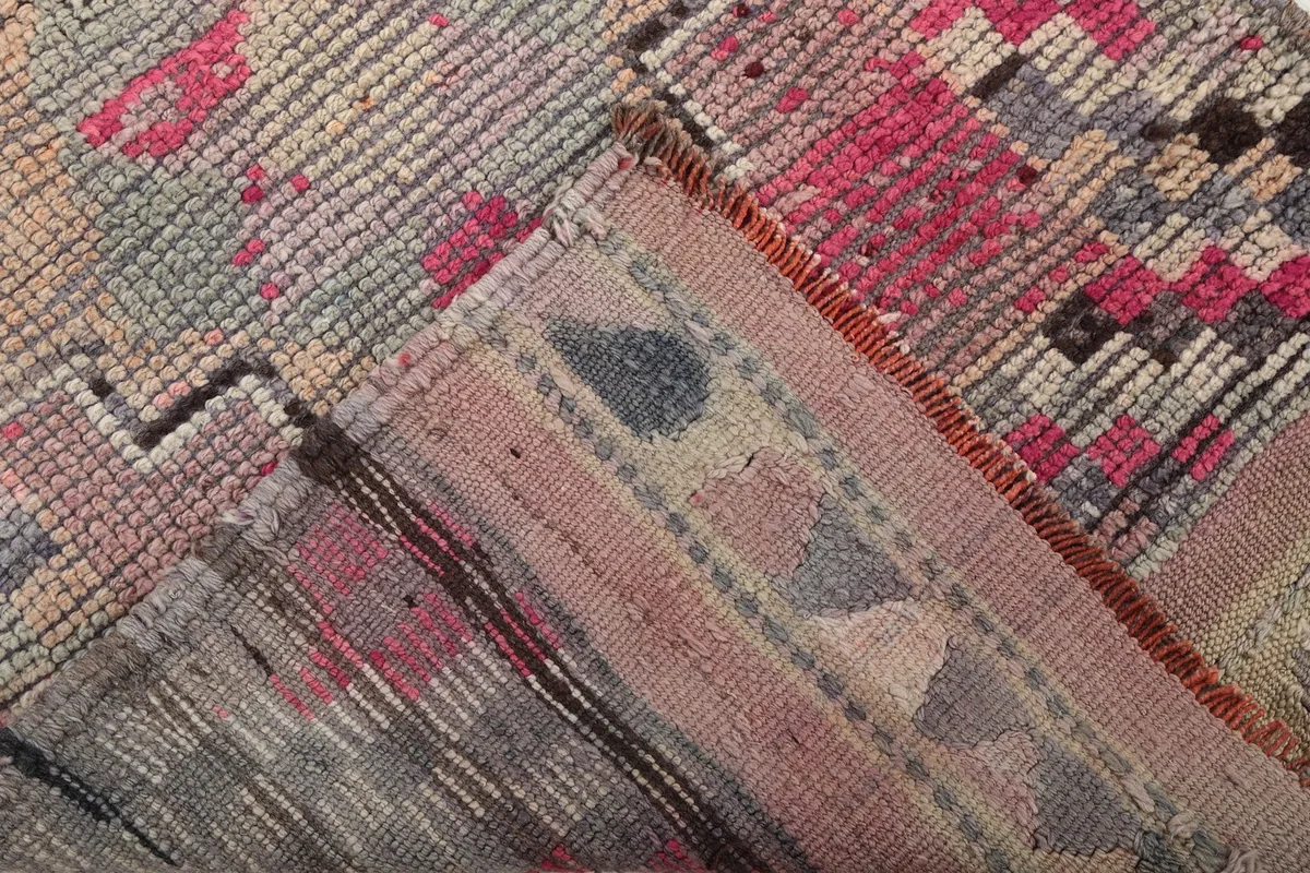 Close-up of the reverse side of the rug, showing the cotton foundation and hand-knotted construction.