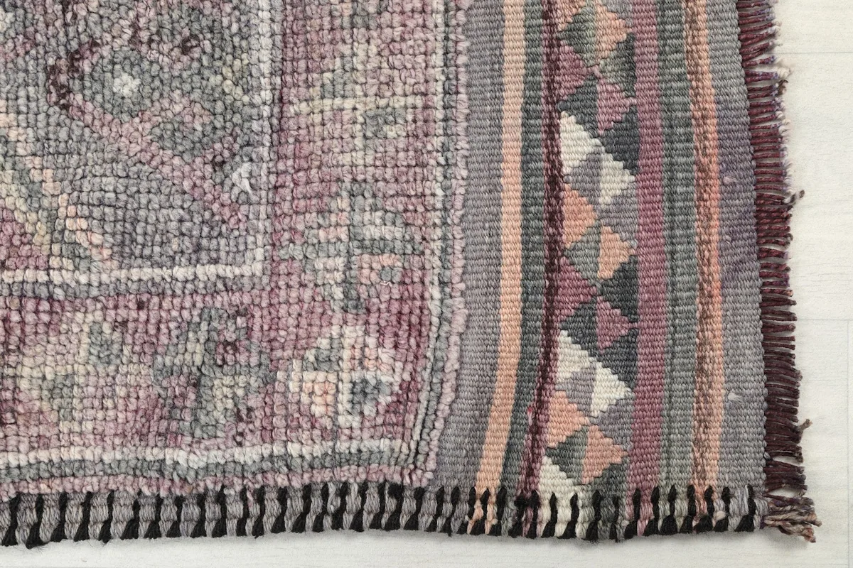 Detailed view of the runner's end, showing the border patterns and flatweave finish.