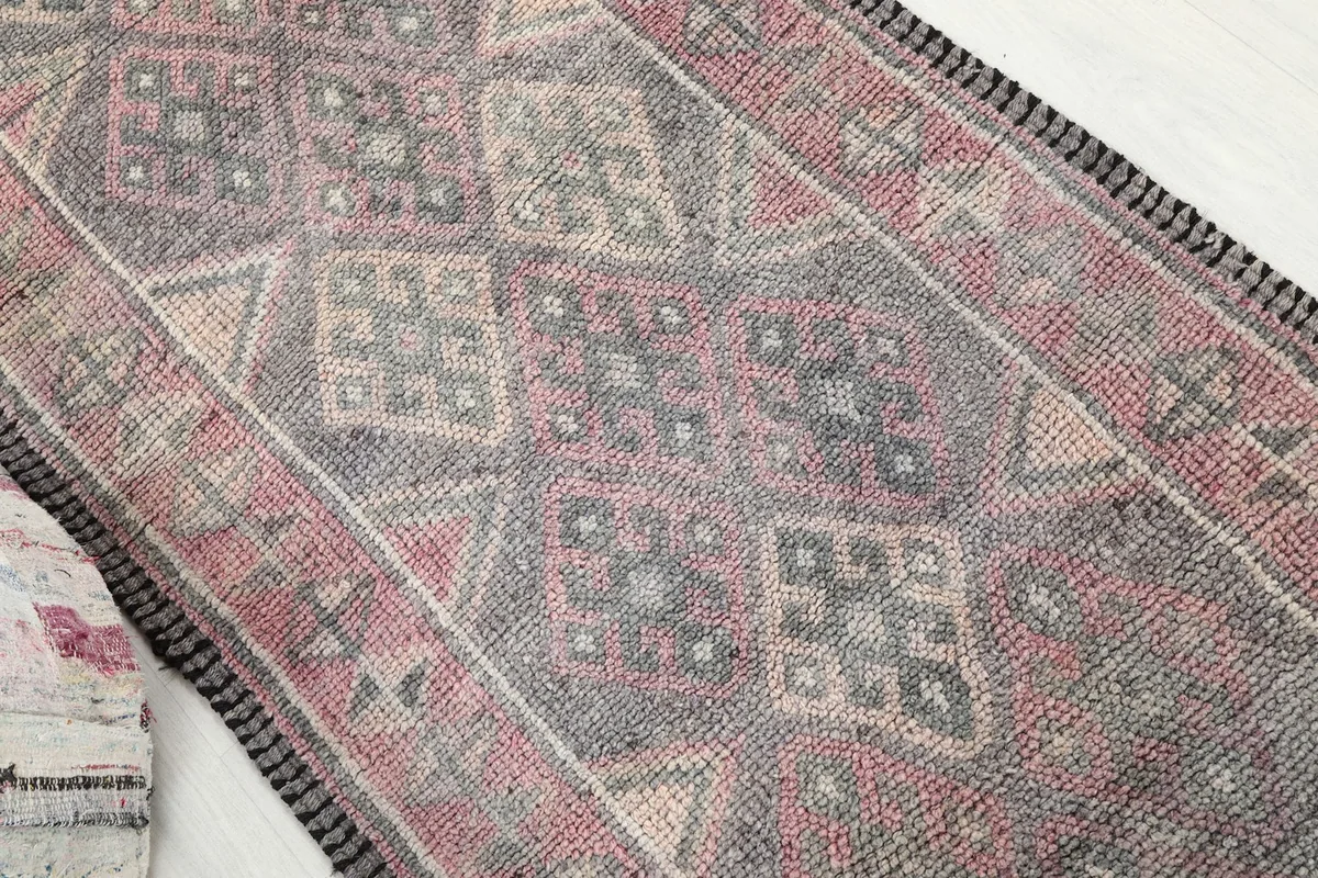 Overhead close-up of the rug's central geometric and diamond motifs.