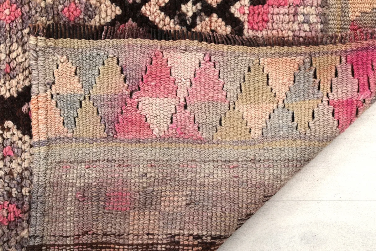 Close-up of the reverse side of the hand-knotted wool rug, revealing the cotton foundation