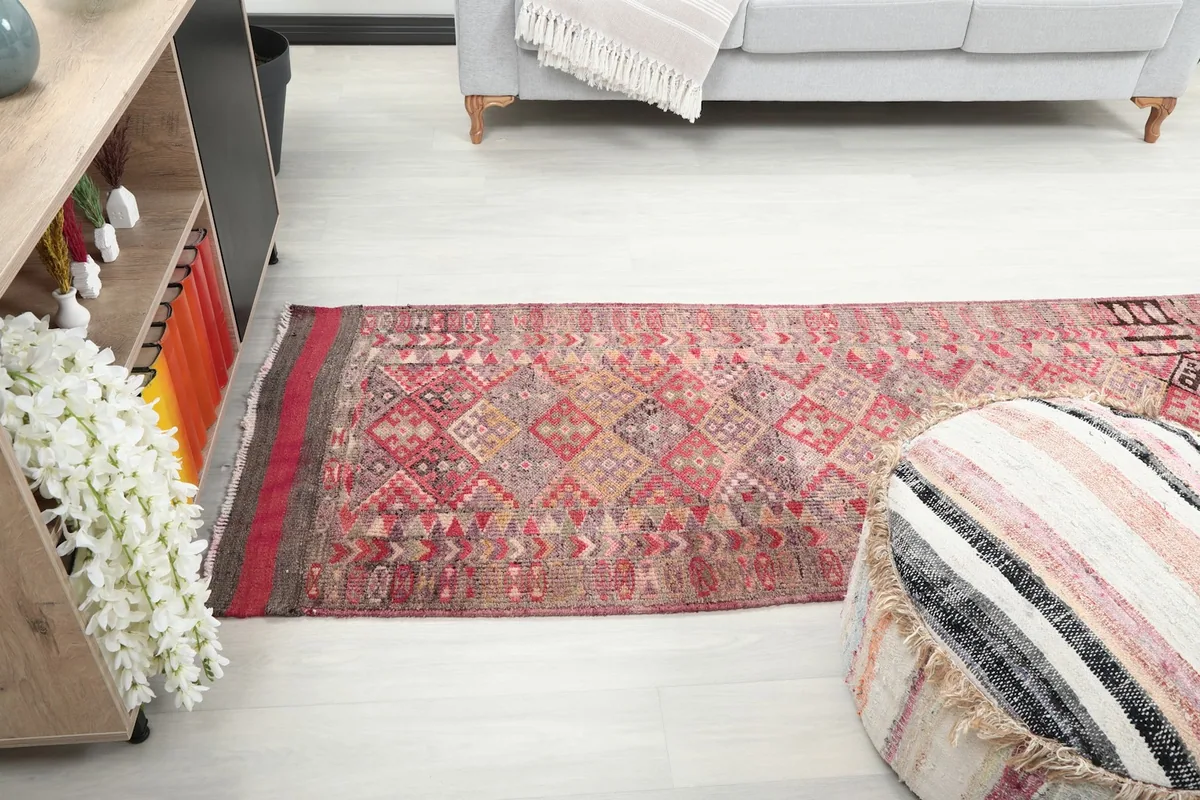 Runner rug laid out in a room, offering a perspective of its full length
