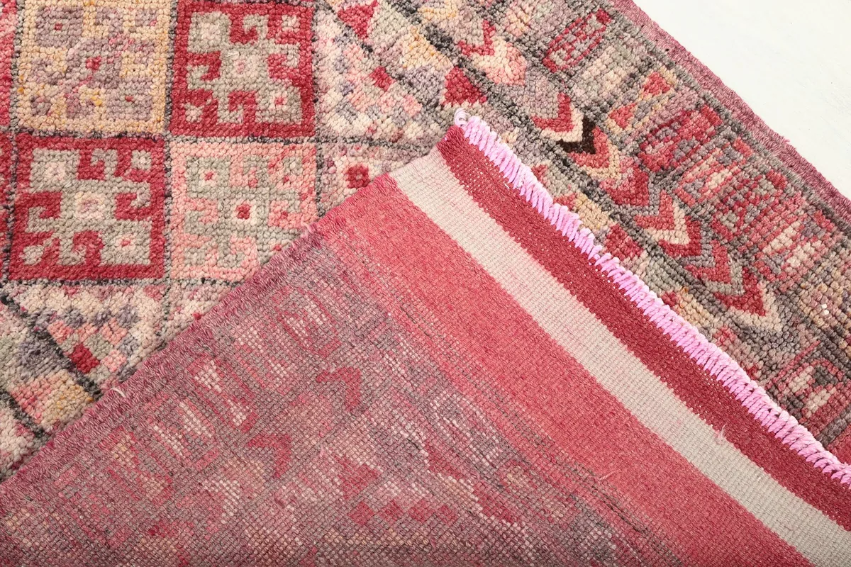 Underside of the rug, revealing the cotton foundation and hand-knotted structure